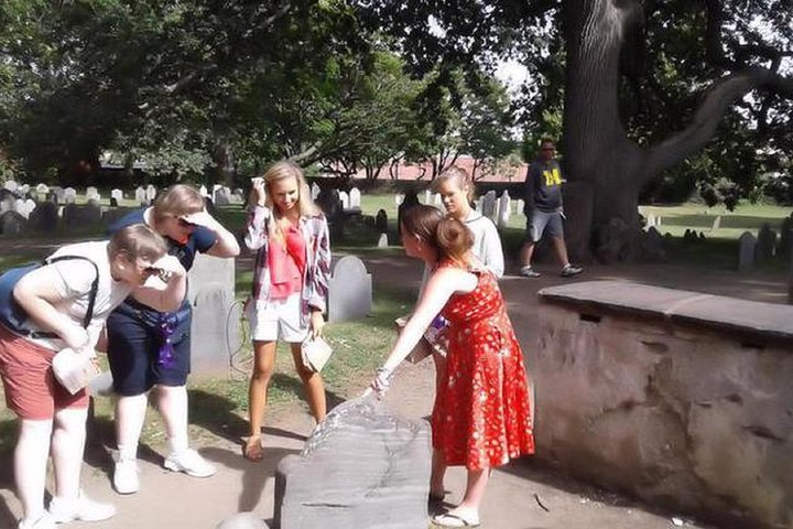 Guide pointing out an important grave stone at the Old Burial Point 